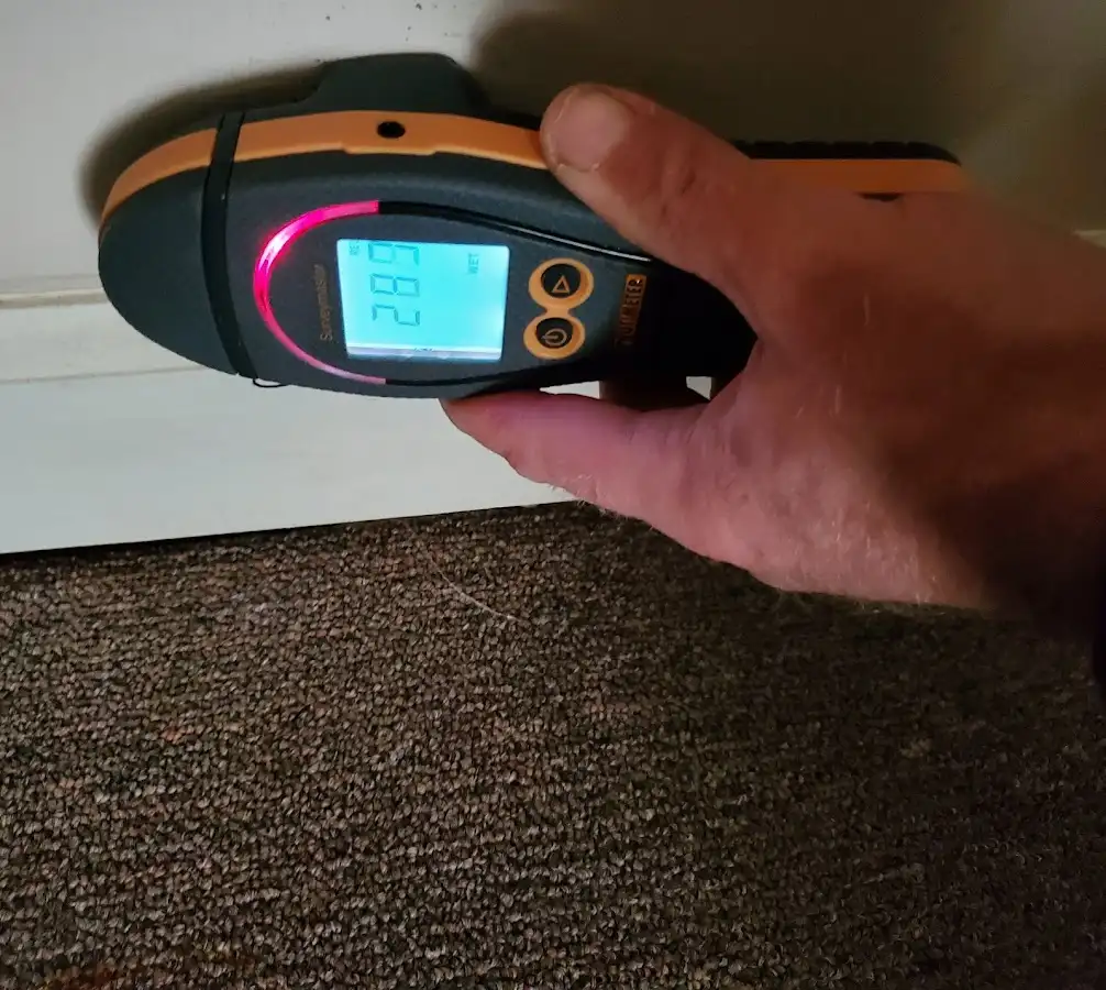 Moisture detection at baseboard during Storm Damage Restoration in Pratt